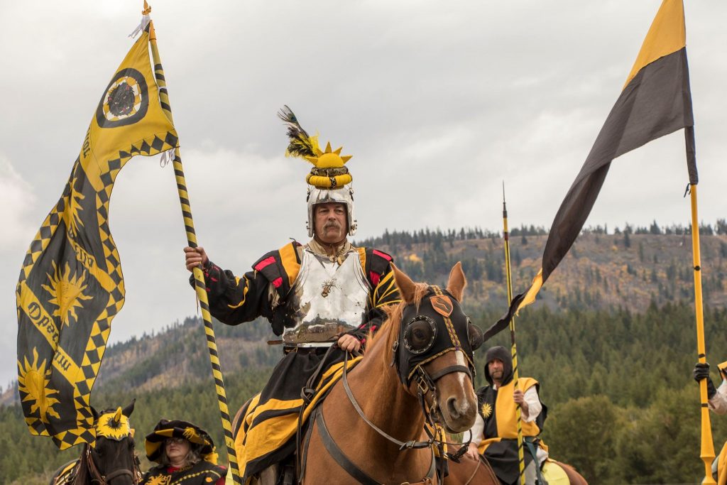 A rider in black and gold finery processes in to the arena
